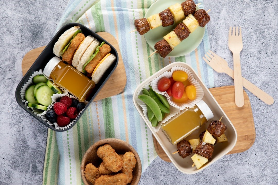 a-couple-of-trays-filled-with-food-on-top-of-a-table-acthniy6ebc
